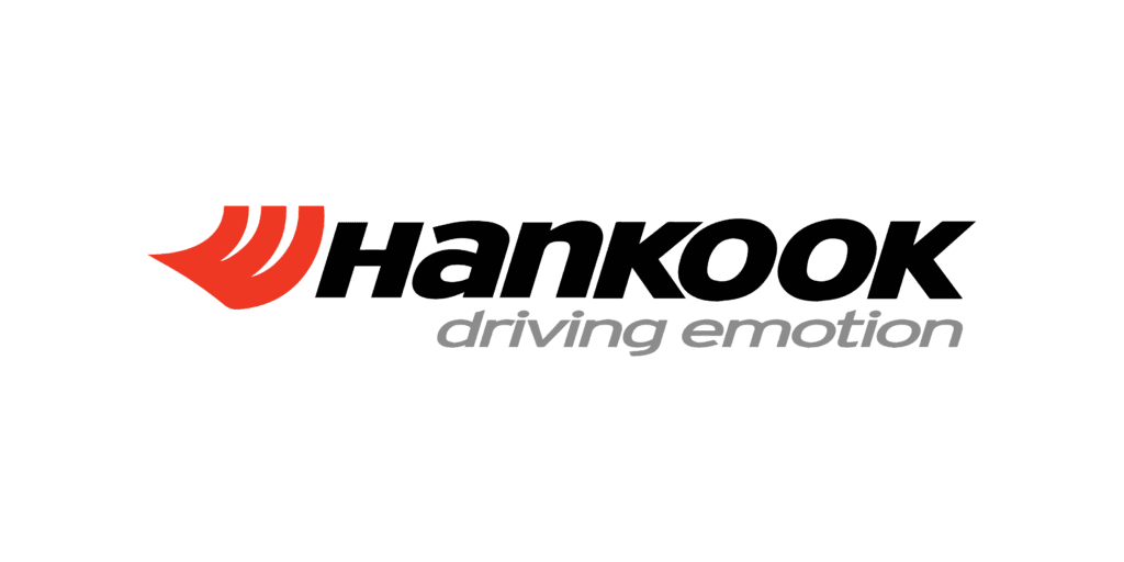 The image shows the logo of hankook tire, featuring a stylized red and orange flame-like symbol to the left of the word "hankook" in bold black lettering, followed by the tagline "driving emotion" in lowercase letters.